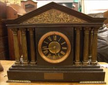 A 19th century gilt bronze mounted black slate mantel clock Of architectural form, the dial with