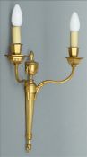 A set of four gilt metal wall lights. Each of twin branch form. 40 cms high. (4)