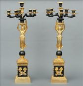 A pair of gilded Empire style candelabra The five branch tops supported on an angel form column