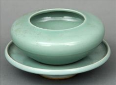 A Chinese porcelain celadon glaze inkwell and stand The inkwell of compressed form, the stand with