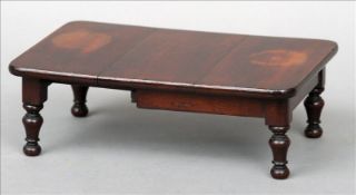 A Victorian mahogany miniature wind-out extending dining table The rounded rectangular top including
