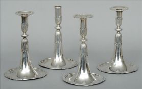 A match set of four 18th century Swiss candlesticks, hallmarked Lausanne Each of trumpet form with