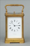 A 19th century brass cased repeating carriage clock The loop swing handle above twin hour and five