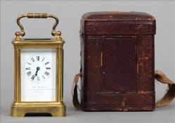 A late Victorian brass framed miniature carriage clock The white enamel dial with Roman numerals and