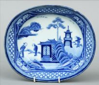 A Chinese blue and white porcelain bowl Of oval form, decorated with figures in a garden