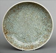 A Chinese celadon crackle glaze dish The green ground with typical patination. 28 cms diameter.
