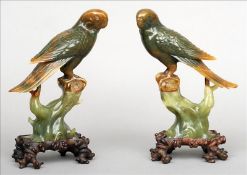 A pair of Chinese carved jadeite budgerigars Each naturalistically modelled perched atop a stump,