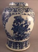 A 19th century Chinese blue and white porcelain vase Decorated with floral vignettes on a lotus
