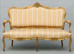 A 19th century Louis XV style gilt framed settee The carved serpentine top rail above the