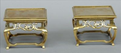 A pair of 19th century Chinese bronze stands The galleried square section top above a pierced
