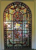 A large sectional leaded stained glass panel The two part frame consisting of six base panels and