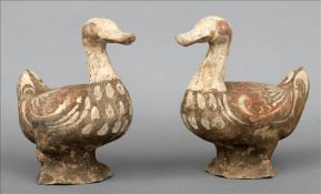 A pair of Tang Dynasty pottery models of ducks Each modelled naturalistically with painted detail.