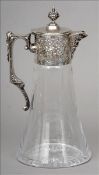 A Portuguese silver mounted claret jug The finial mounted hinged lid above a florally embossed