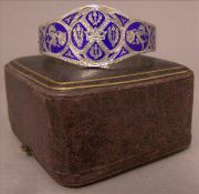 A Victorian white metal and blue enamelled hinged bracelet Decorated with Scottish related motifs