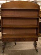 A pair of George IV mahogany waterfall bookcases Each domed top above four graduated shelves, one
