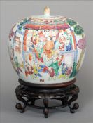 A Chinese Canton porcelain ginger jar and cover on stand Decorated overall with various figures in a