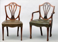 A set of seven George III mahogany dining chairs, including one with arms The shield backs with