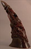 A Chinese carved horn cup Worked with birds amongst floral sprays. 23 cms long. Generally in good