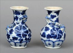 A pair of small 19th century Chinese blue and white vases Each with floral decorations and twin