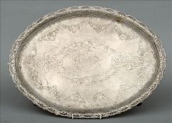 An early 19th century silver tray With a pierced embossed border and engraved fruiting swags and