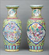 A pair of Cantonese enamel decorated vases Each with a yellow ground and vignettes of warriors at