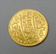 An Indian Murshidabad gold coin Each side with script. Some general wear, approximately 12 grammes.