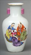 A Chinese porcelain vase Of baluster form, decorated with figures opposing a pine tree, red