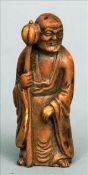 A Chinese carved hardston figure of a sage Modelled holding a staff and a gourd, standing on a