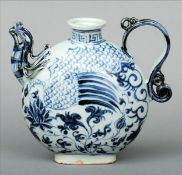 A Chinese blue and white porcelain teapot Modelled and painted as a phoenix above floral sprays.