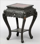 A late 19th century Chinese carved wooden jardiniere stand The geometrically carved square section