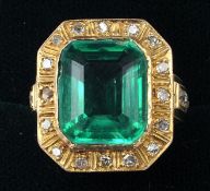 A Victorian green stone and diamond set unmarked gold ring The central green stone bordered by a