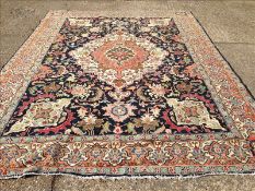 A Tabriz wool carpet The midnight blue field enclosing a central stepped medallion and scrolling