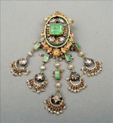 An Indian unmarked yellow metal emerald, ruby, diamond and pearl set pendant/brooch The main oval