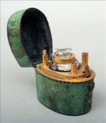 A 19th century shagreen cased travelling inkwell The hinged lid enclosing a faceted glass inkwell