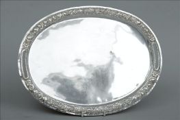 A 19th century Maltese silver twin handled glove tray Of oval form with flowerhead embossed border