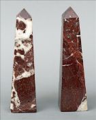 A pair of variegated rouge marble obelisks Each of typical form. 25 cms high. (2) Some wear to