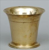 An 18th century bronze mortar The flared neck rim above a plain cylindrical tapering body,