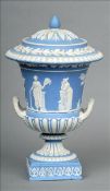 A 19th century Wedgwood jasperware campana form urn and cover The finial mounted lid above bands