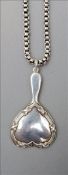 An unmarked white metal chain hung with a small heart shaped silver hand mirror, hallmarked
