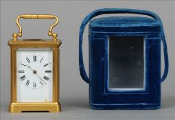 A late 19th/early 20th century brass framed miniature carriage clock The swing handle above a