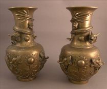 A pair of Japanese bronze vases Each modelled with dragons chasing a flaming pearl, moulded