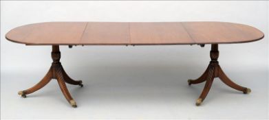 An early 20th century 18th century style mahogany twin pillar dining table The D-end top