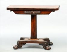 An early 19th century rosewood card table The hinged moulded rounded rectangular swivel top