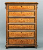 A 19th century Continental walnut chest of drawers The shaped stepped rectangular top above six