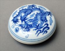 A Chinese porcelain blue and white box and cover Of circular form, decorated with a five-clawed