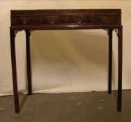 An Edwardian mahogany card table The crossbanded hinged rectangular top with a baize lined