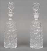 A pair of Whitefriars clear glass Glacier decanters and stoppers, designed by Geoffrey Baxter Both