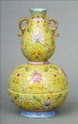 A Chinese porcelain box and cover Modelled as a twin handled double gourd vase decorated with