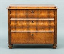 A 19th century Continental mahogany chest of drawers The stepped rounded rectangular top above two