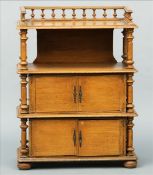 A 19th century scumbled pine whatnot The three quarter galleried top above three rounded rectangular